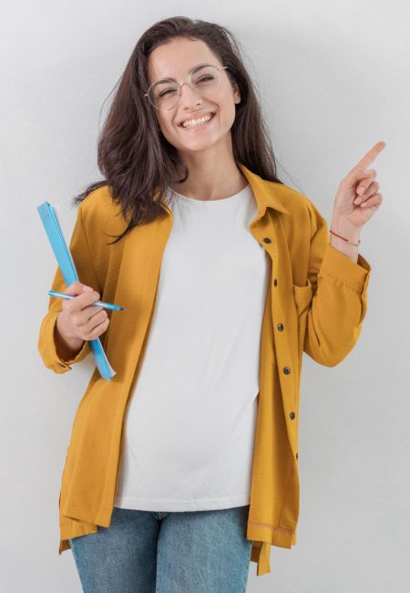 smiley-pregnant-woman-holding-clipboard-pointing-up